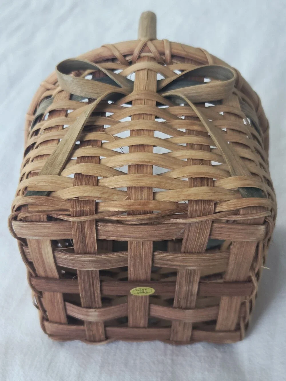 Vintage, Hand-Woven Basket Featuring A Unique Bow Detail And Green Accent